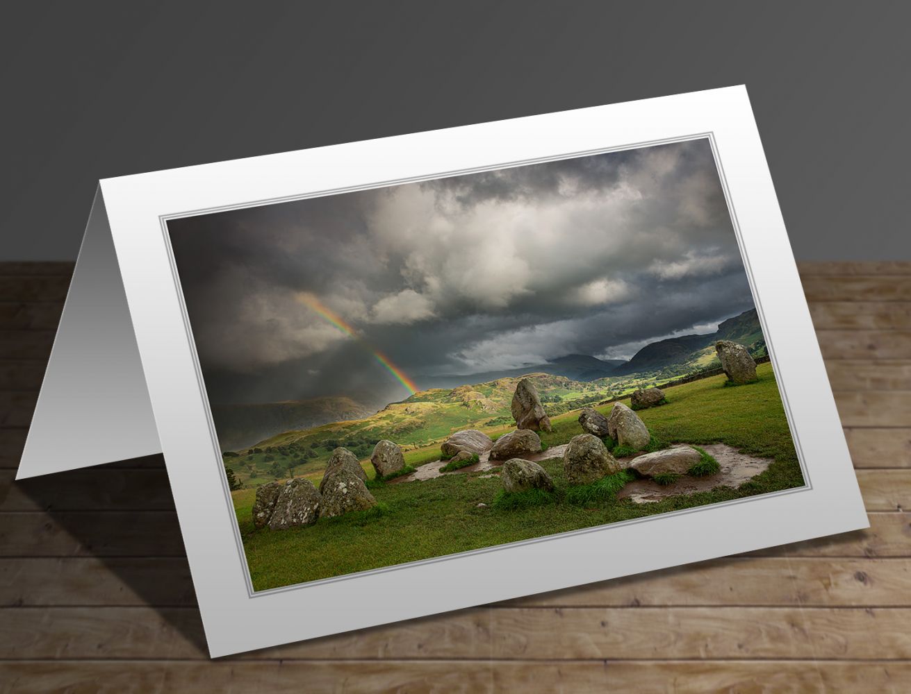 A greetings card containing the image Rainbow over the Castlerigg Stone Circle by Martin Lawrence