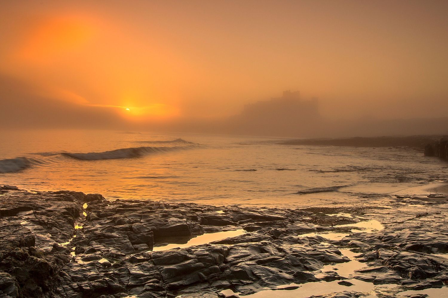 A foggy sunrise at Bamburgh Castle