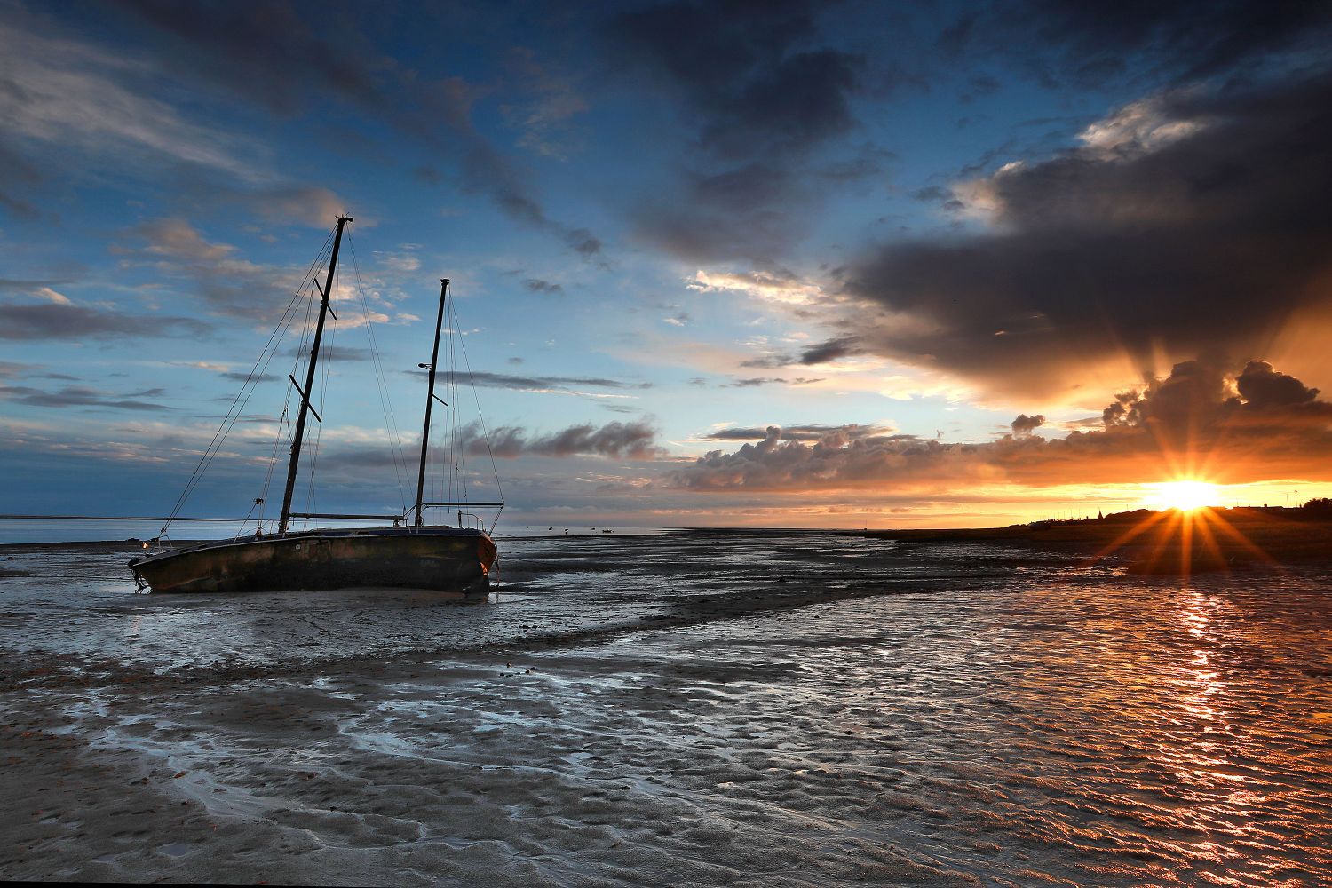 Sunset over the beached yacht at Lytham by Martin Lawrence