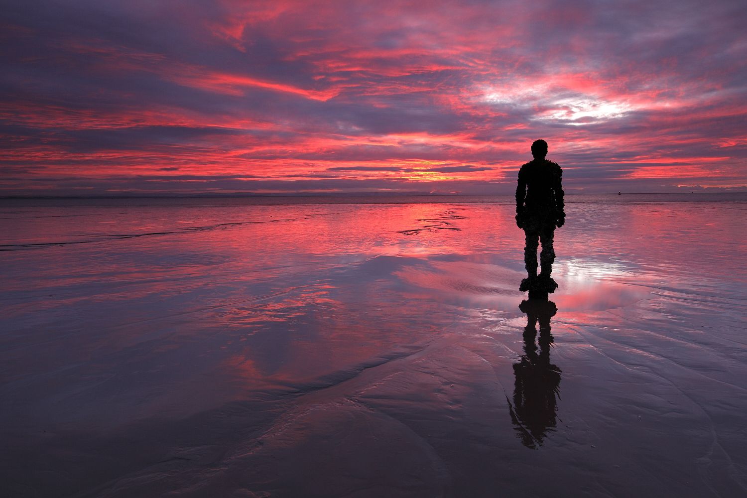 Sunset over Another Place at Crosby Beach