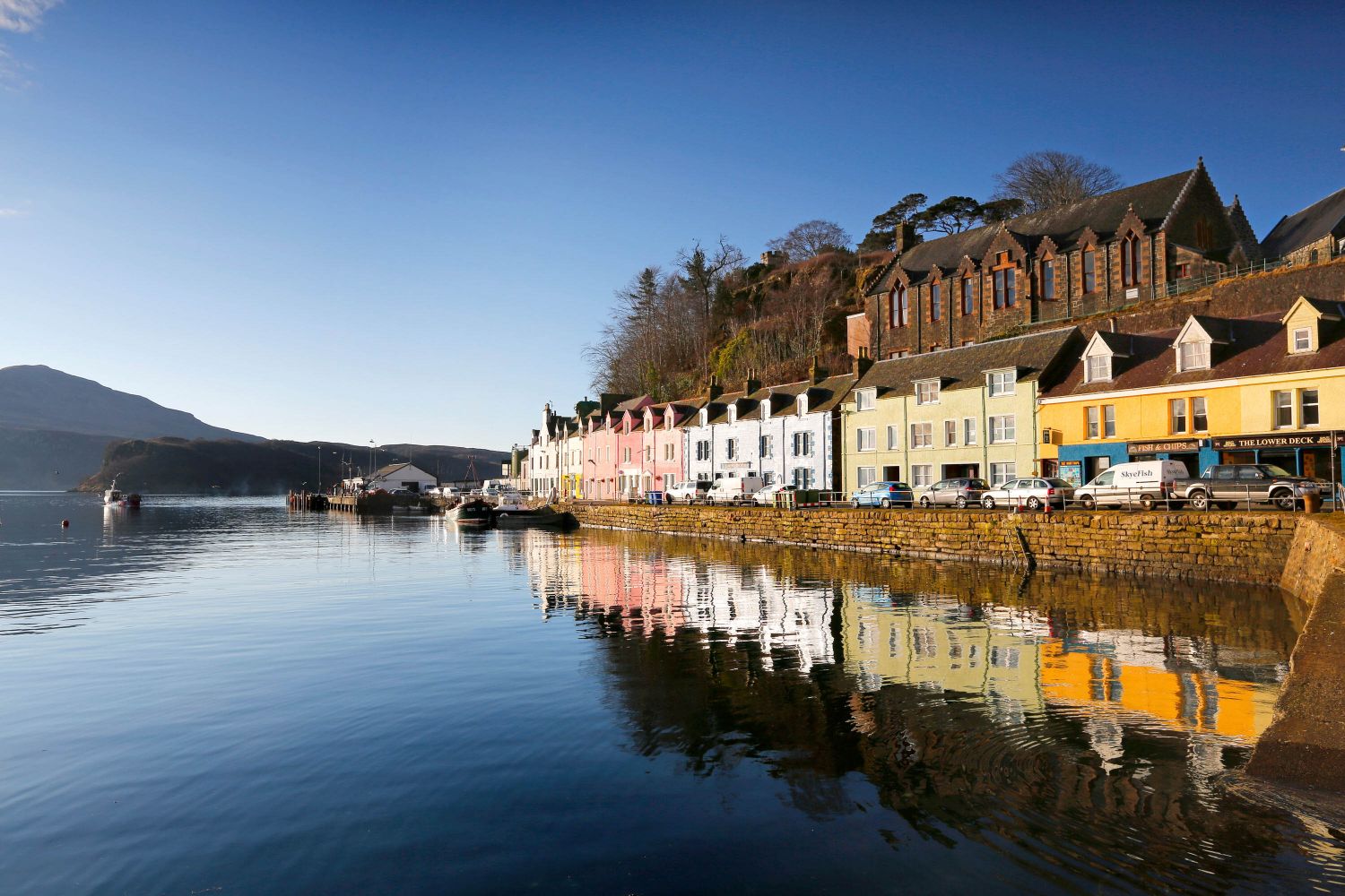 Portree Harbour surrounded by pastel coloured cottages