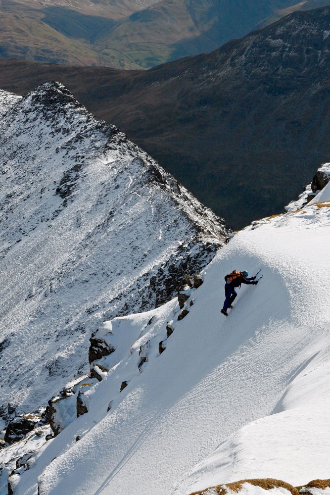 A climber making a thrilling ascent on Helvellyn on a snowy winter's day
