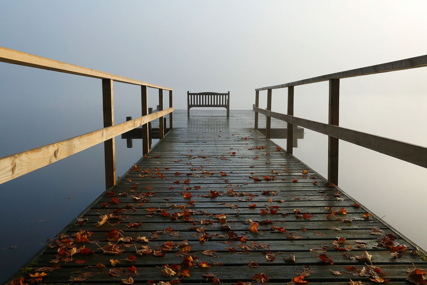 An autumn shot of the jetty at Pullwood Bay on the shores of Windermere in the English Lake District