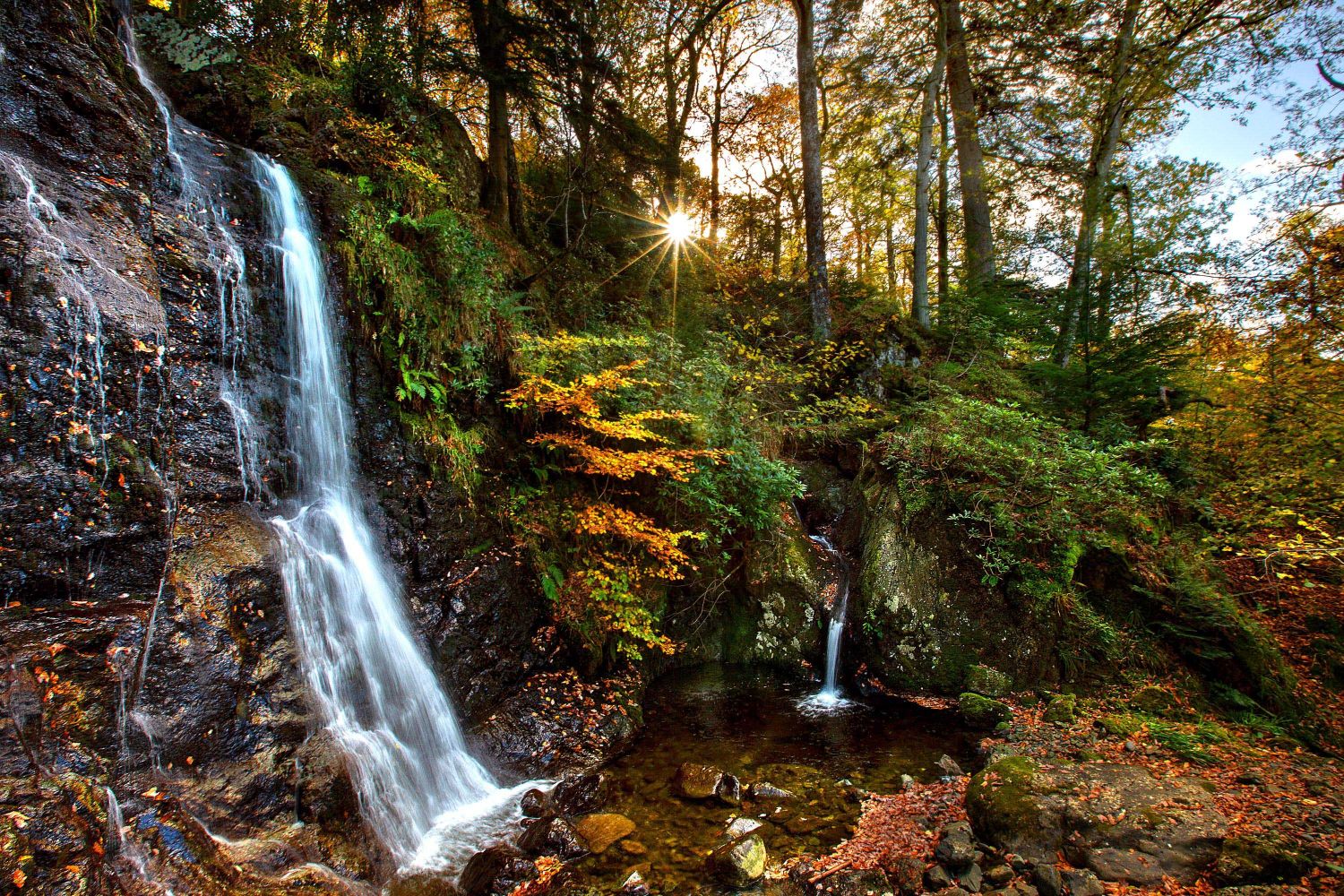 Barrow Cascade Waterfall with water gushing down from the Ashness Fells under Ashness Bridge into Derwent Water.