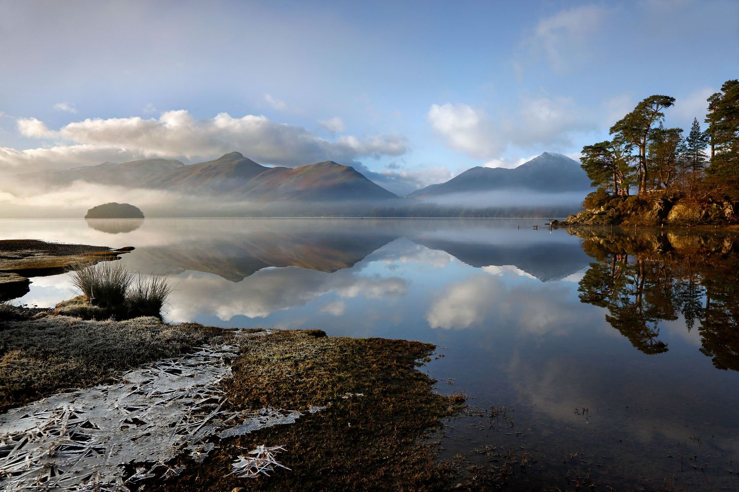 The mist dancing over the lake and the sun lighting up Friars Crag on A Perfect Day at Derwentwater