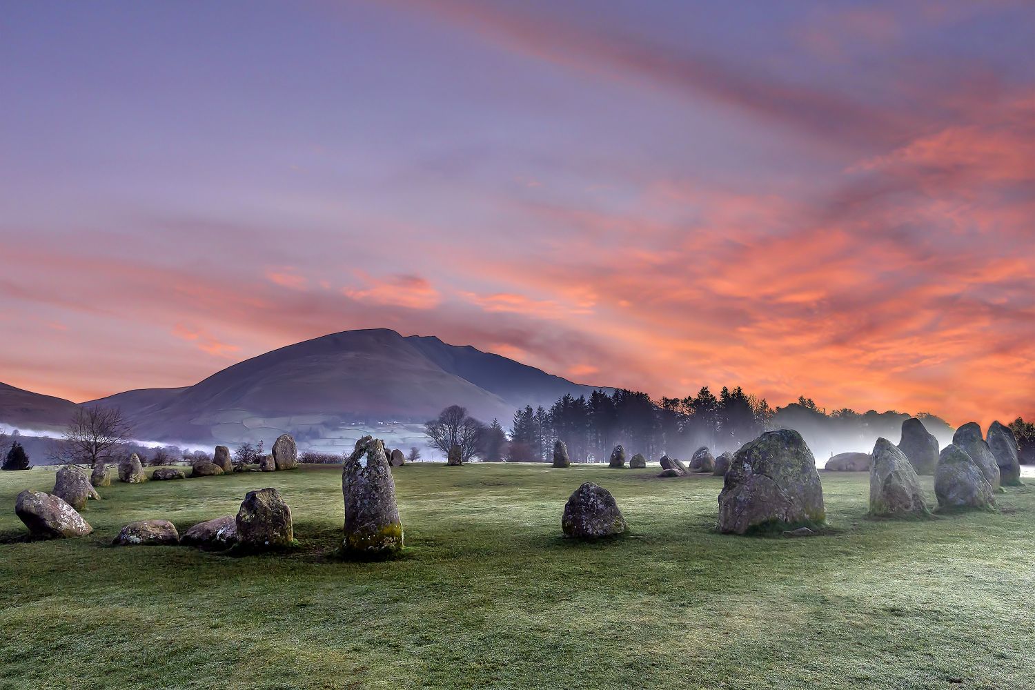 Mist surrounds Castlerigg Stone Circle at sunrise